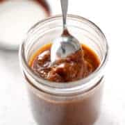 spoon dipping into mason jar of AIP Classic BBQ Sauce