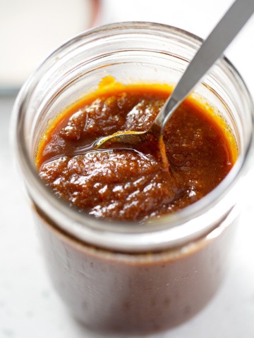 spoon in AIP BBQ Sauce in mason jar