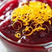 bowl of AIP cranberry sauce with orange zest garnish