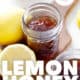 mason jar of Lemon Honey Marmalade with lemons on cutting board