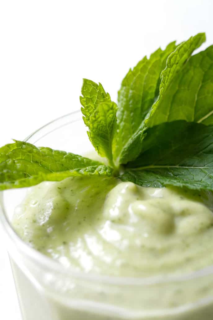 close up of AIP Avocado Smoothie with mint garnish
