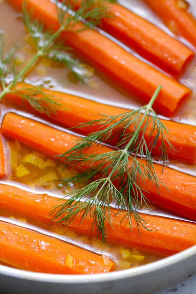 AIP Braised Carrots in pan with fresh dill garnish