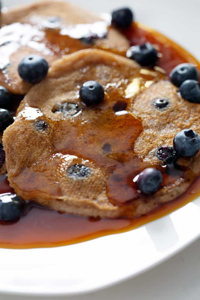 AIP Blueberry Pancakes on white plate with maple syrup
