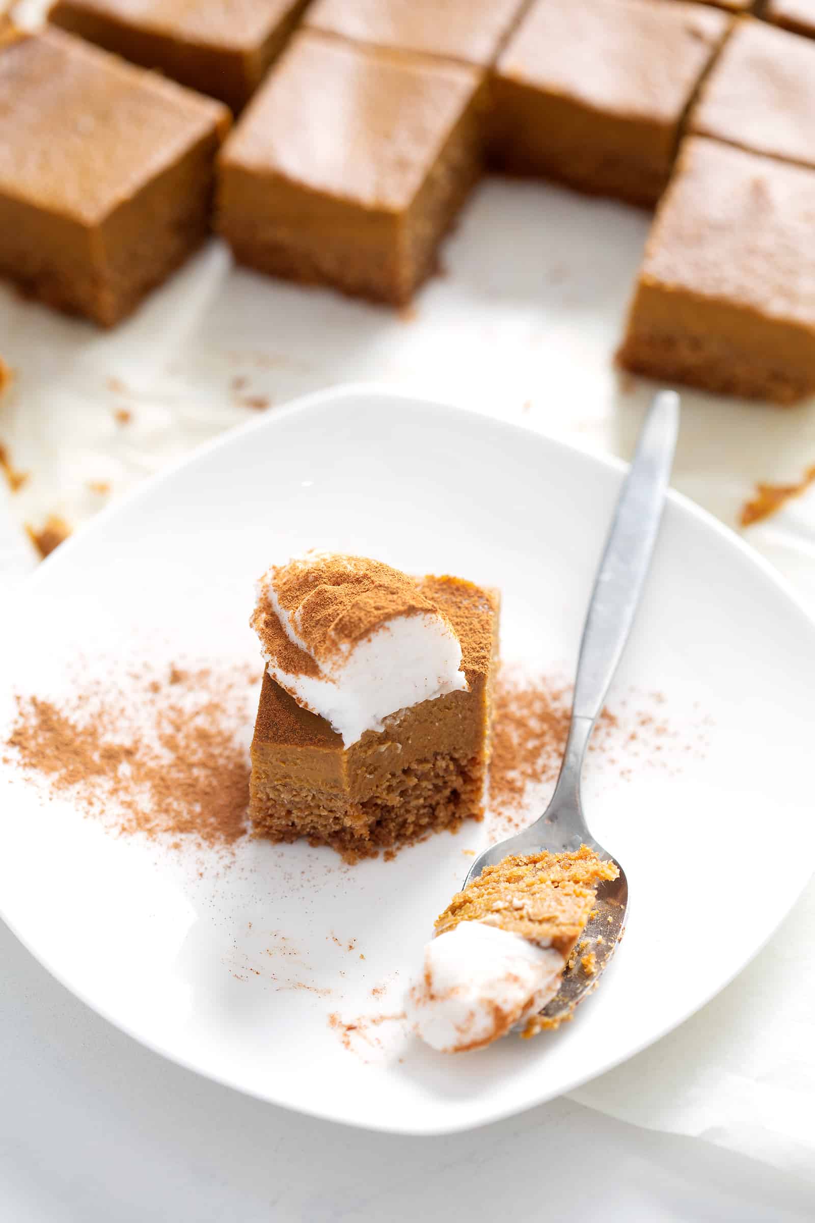 spoonful of AIP Pumpkin Pie Bars on plate with topping 