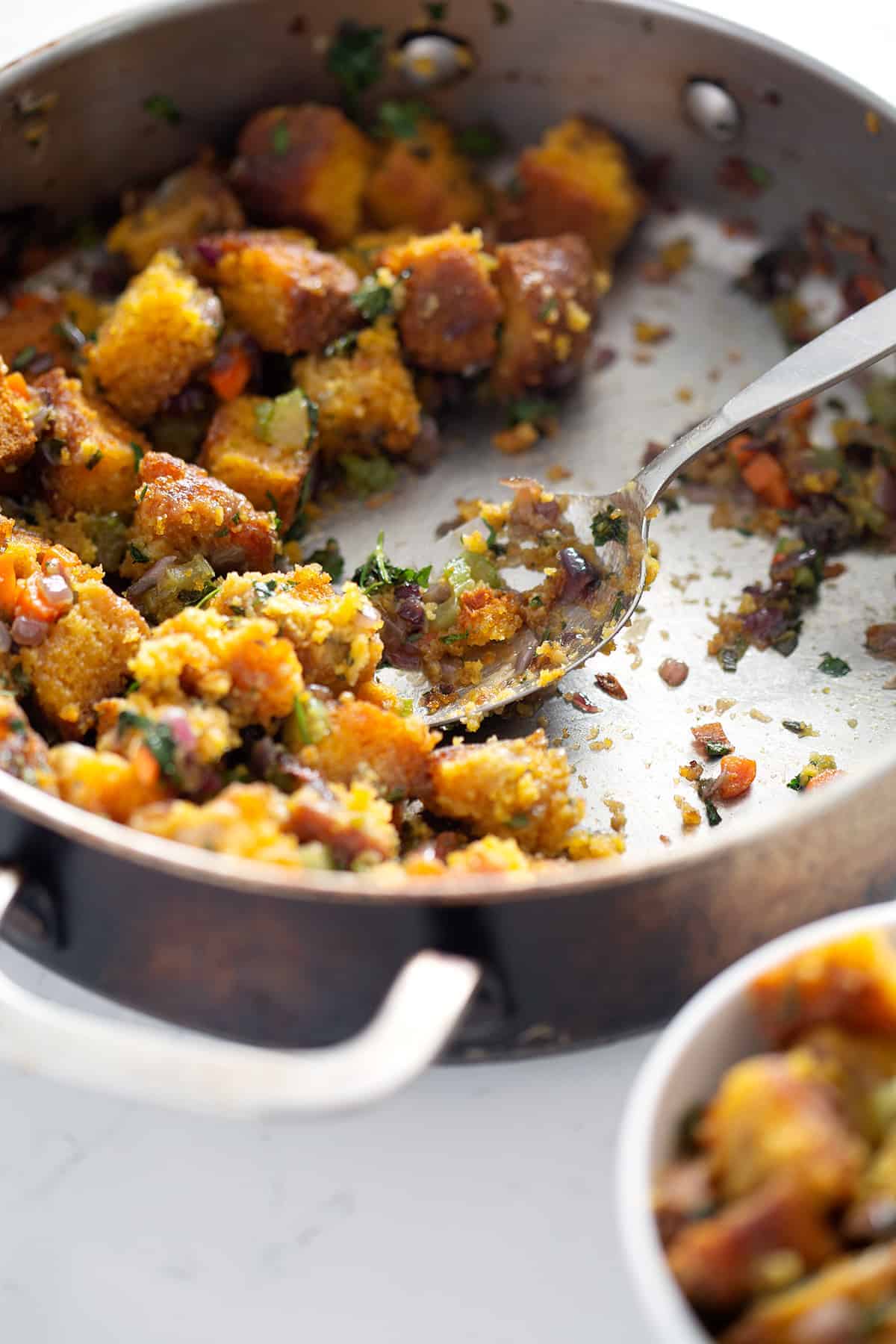 close up of spoon in pan of Paleo Stuffing (AIP, Vegan option)