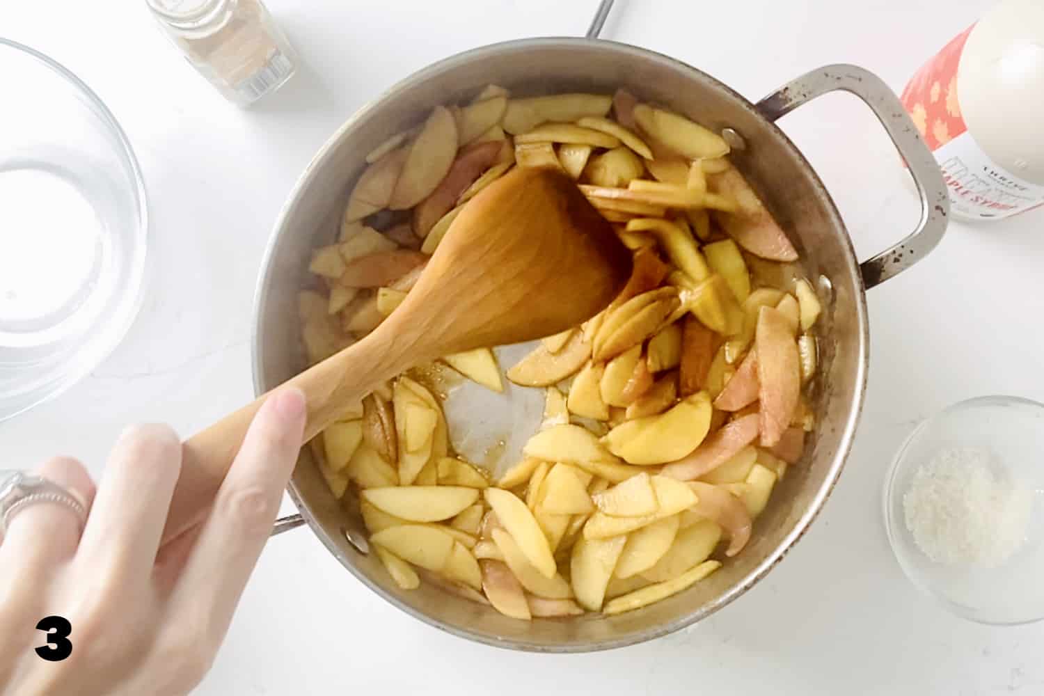 stirring cooked apples in skillet