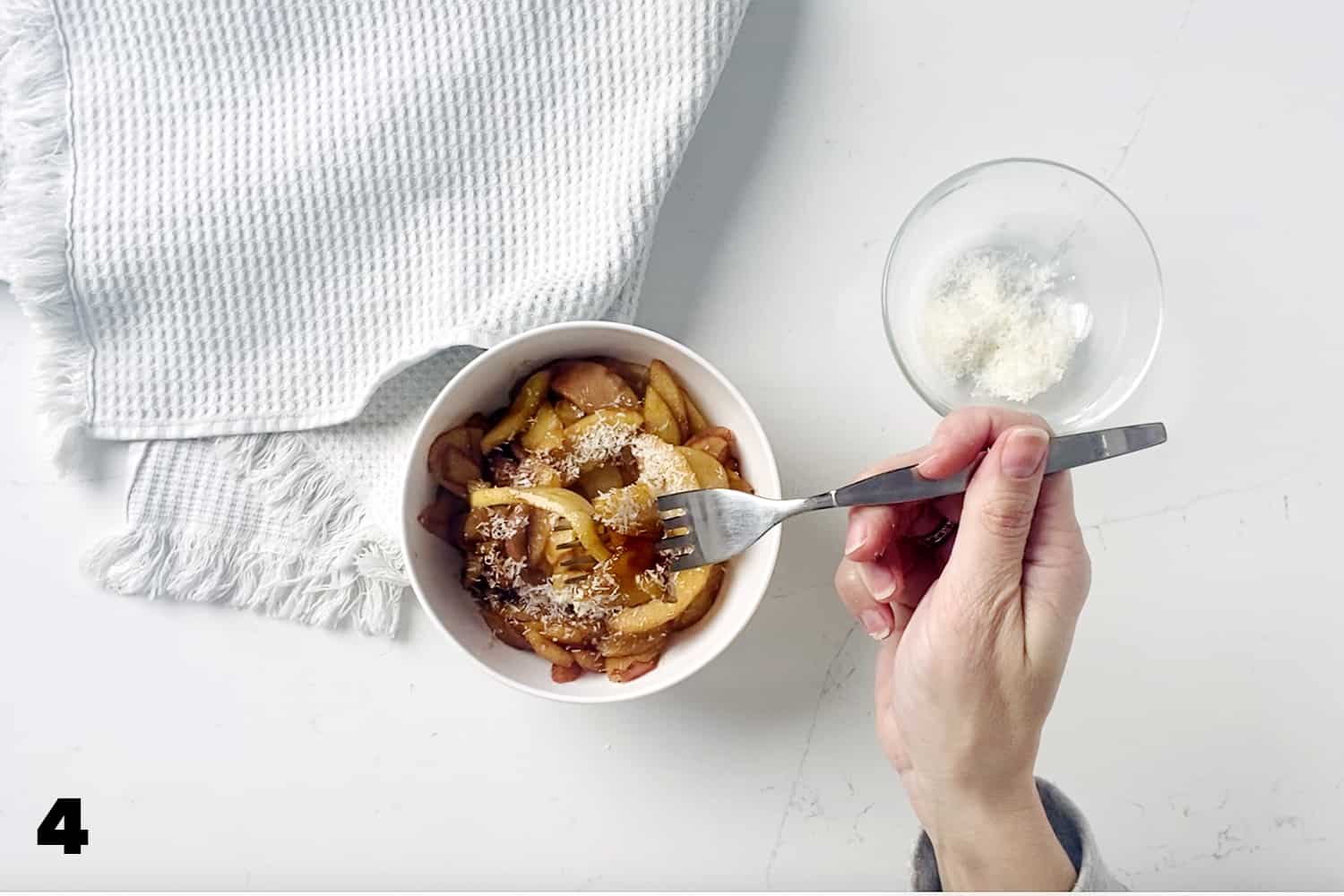 forkful of Healthy Caramelized Apple Topping with bowl.