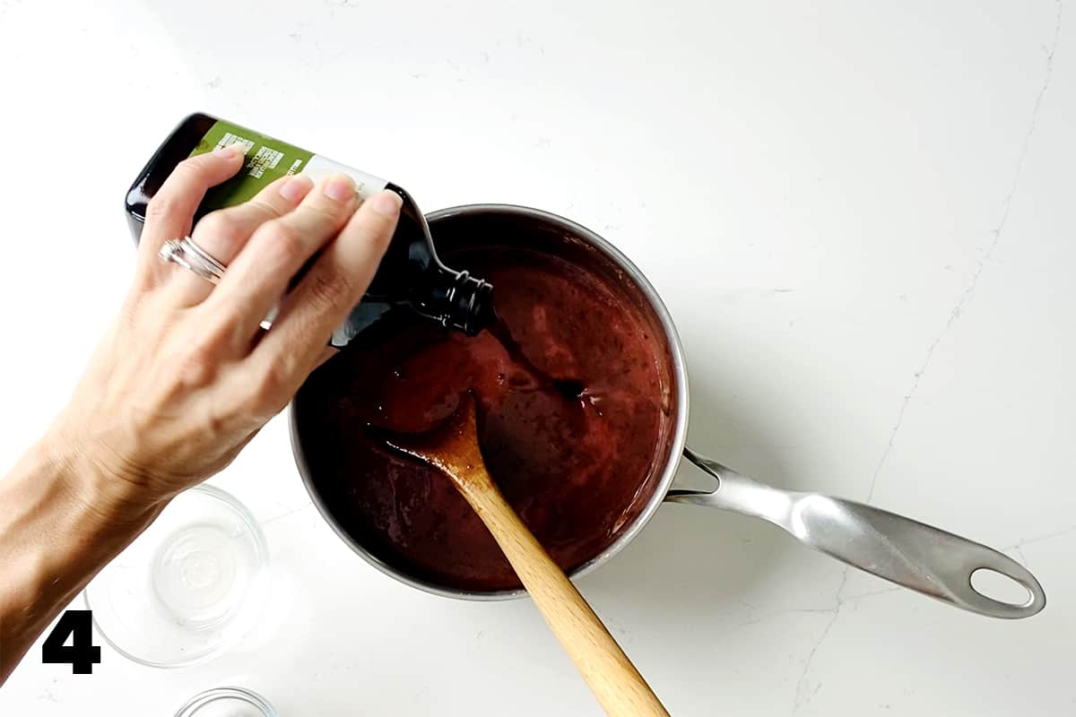 pouring vanilla extract into saucepan
