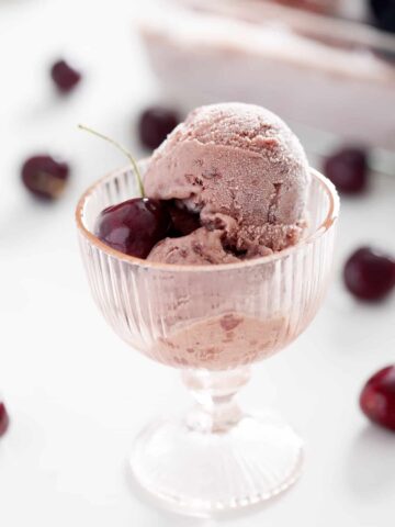 cup of AIP Black Cherry Ice Cream with cherry on top