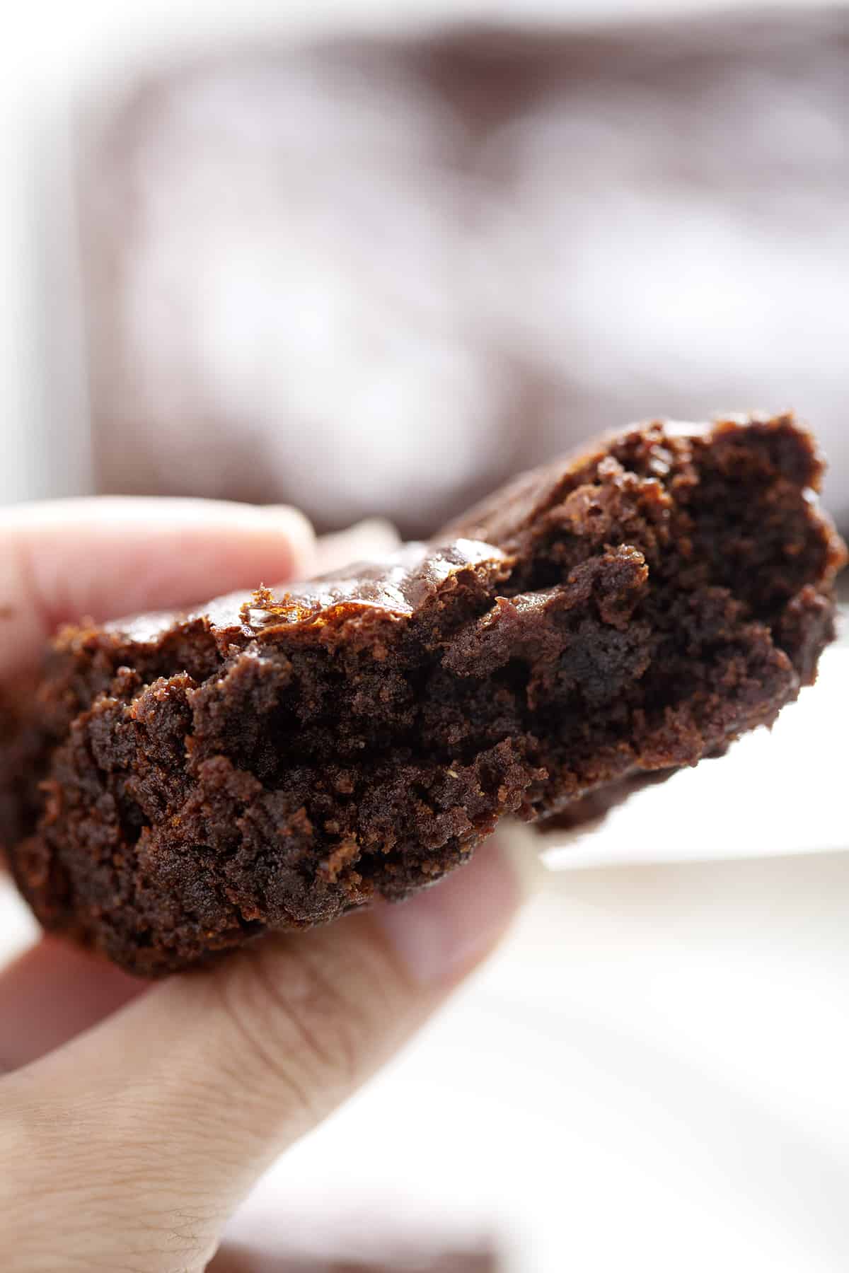 close up of hand holding butter free brownies