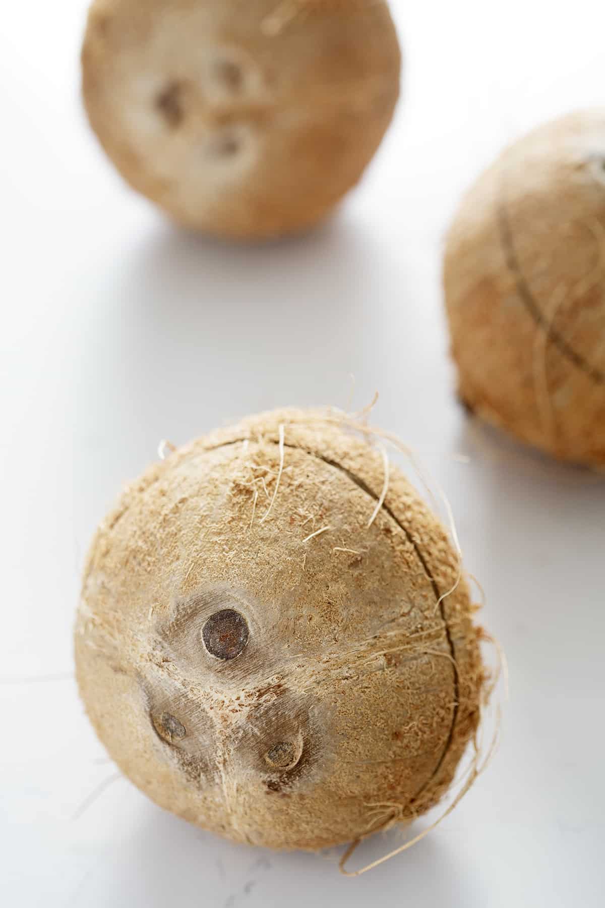three coconuts on white background