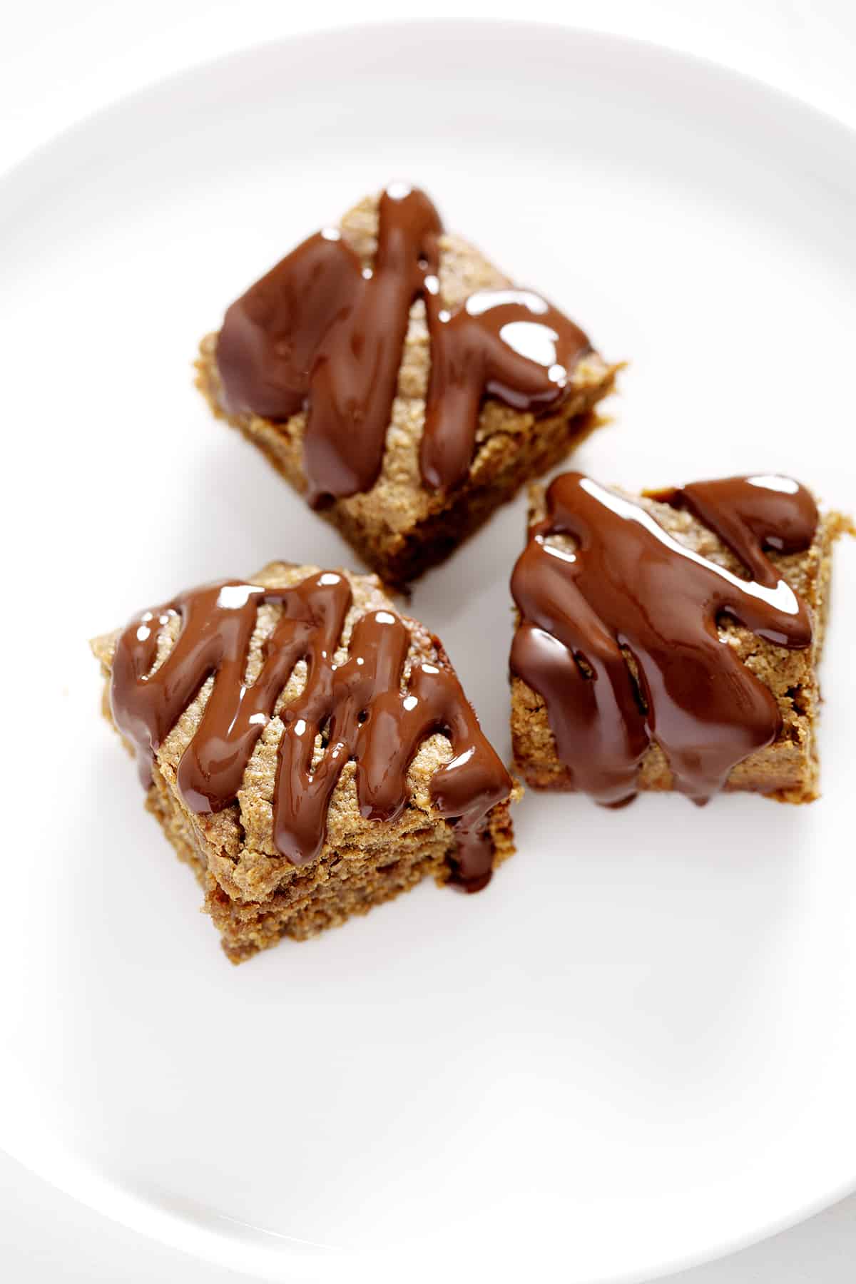 three nut free protein bars on white plate