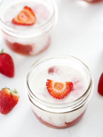 mason jars of AIP strawberry Rhubarb Panna Cotta with Coconut Milk