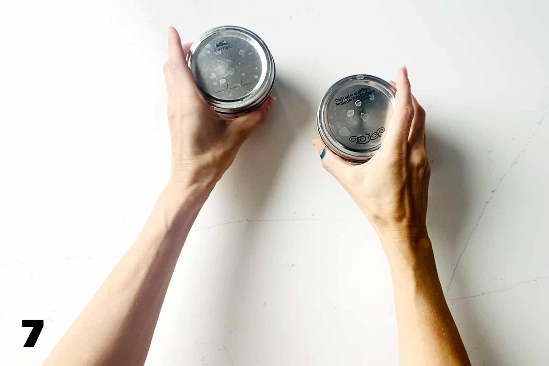 hands grabbing mason jars with lids