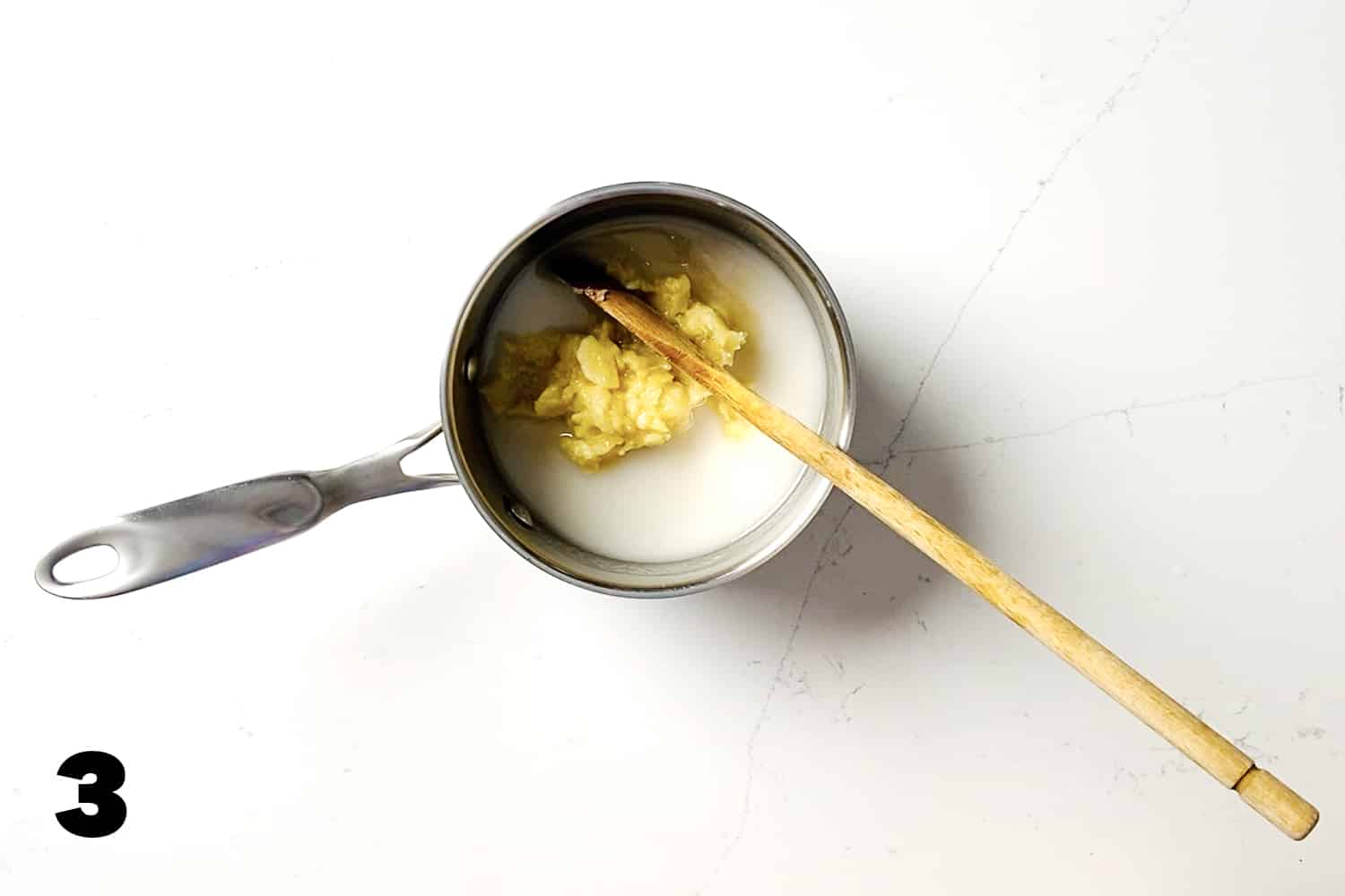 small saucepan with spoon filled with ingredients for AIP fudge