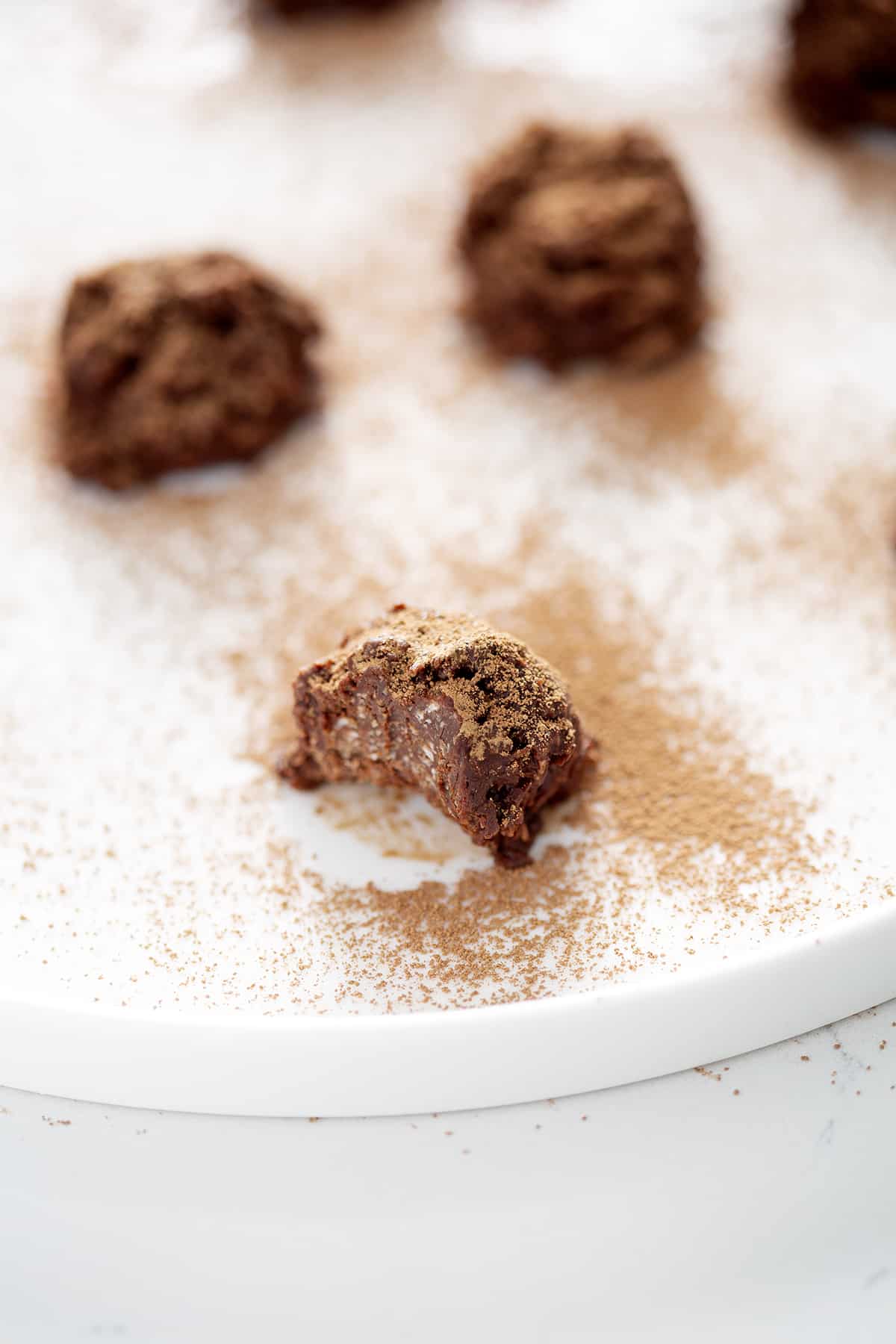 close up of bitten cocoa dusted chocolate truffle