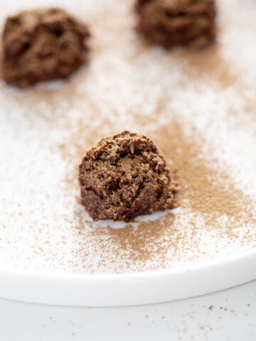 cocoa dusted truffle on white plate