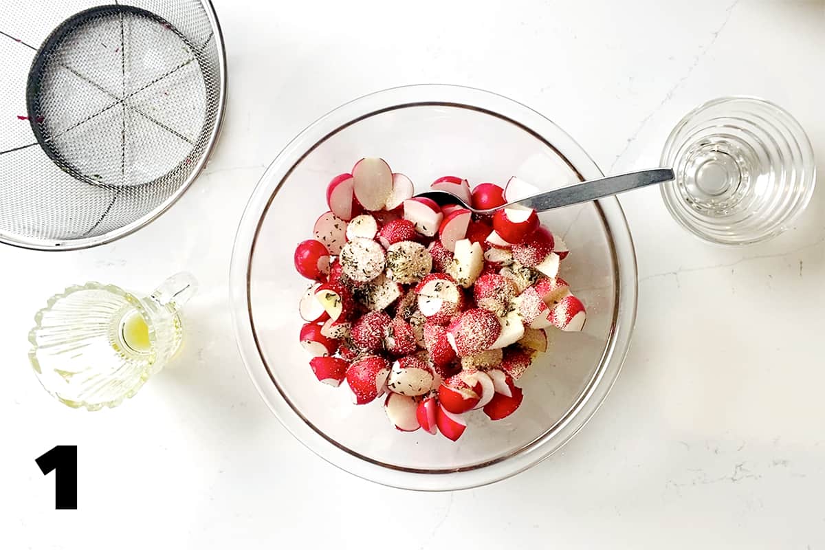 bowl of radishes next to colander and empty glass dishes