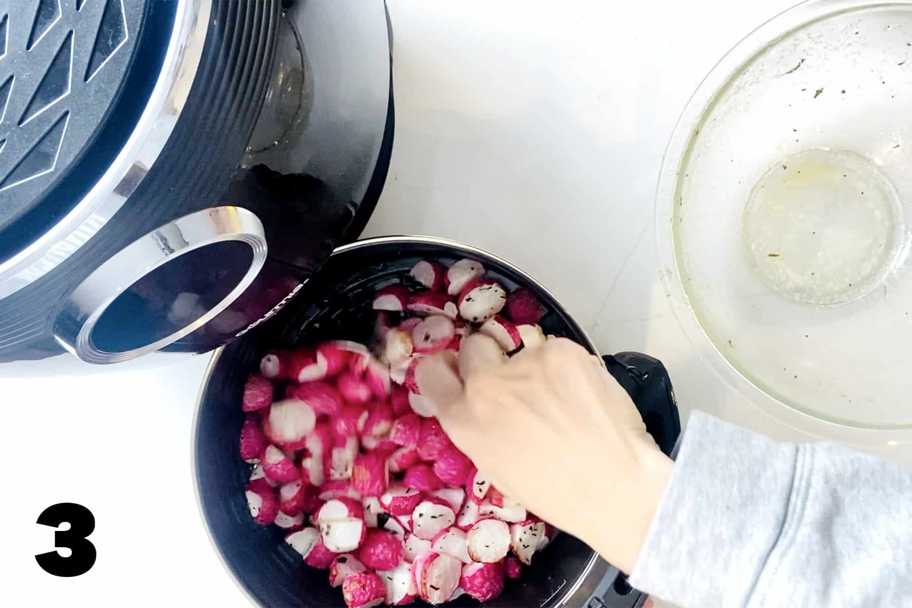 mixing radishes in air fryer basket