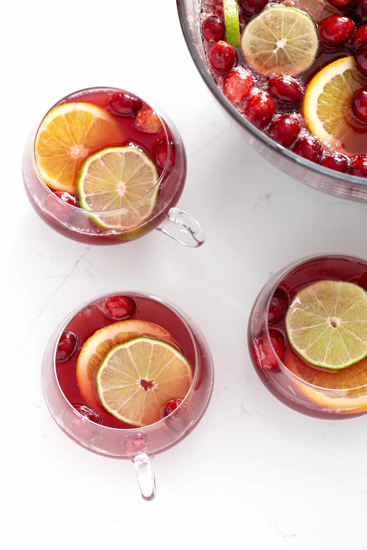 punch bowl and glasses with Christmas Punch, cranberries and citrus slices