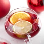 punch glass with non alcoholic Christmas punch, citrus slices and cranberries