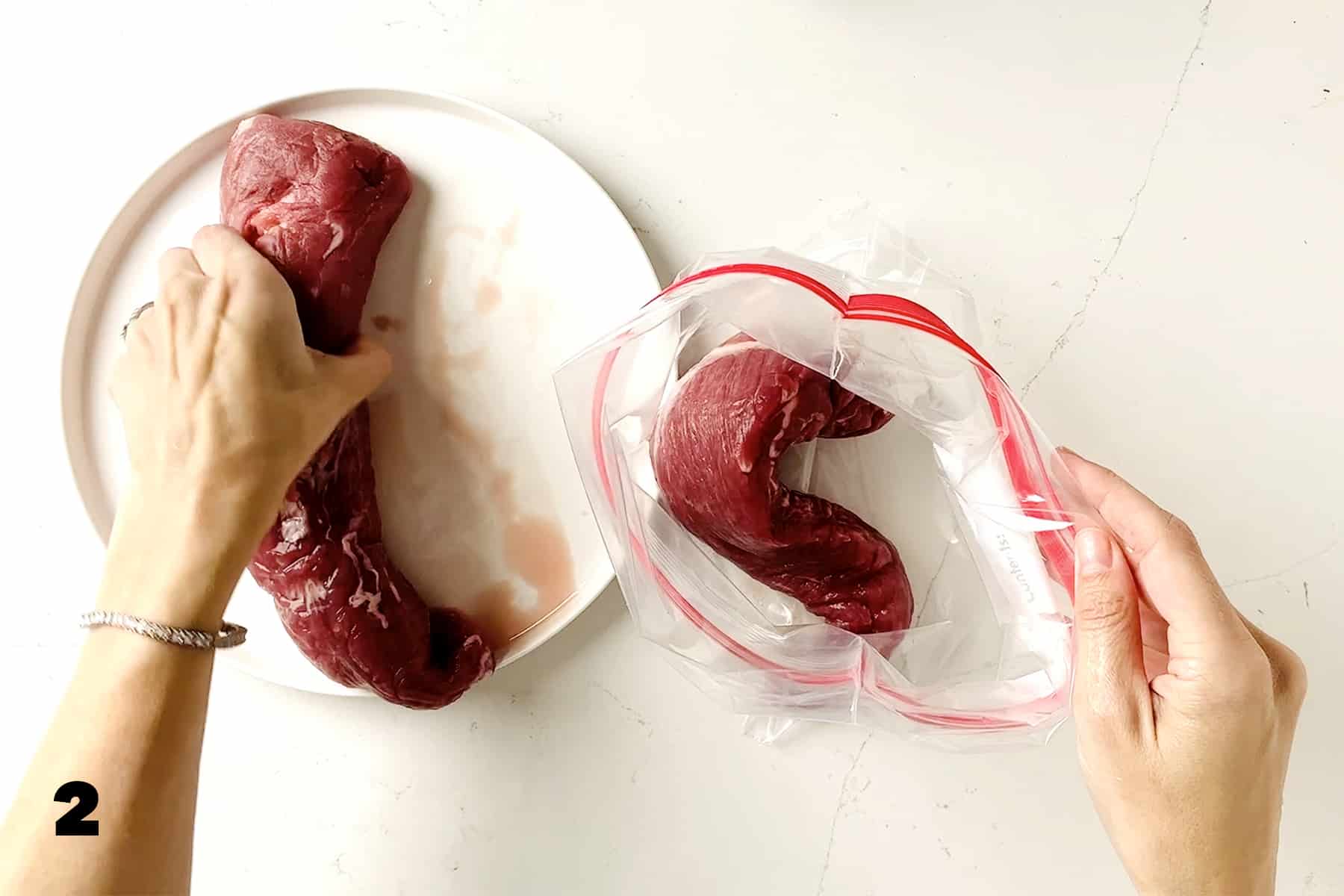 hands putting pork tenderloin into plastic bag