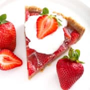 piece of no bake strawberry pie on plate with whipped cream