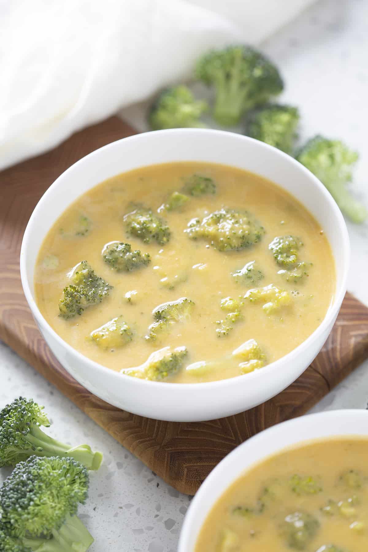 white bowl of vegan broccoli cheddar soup