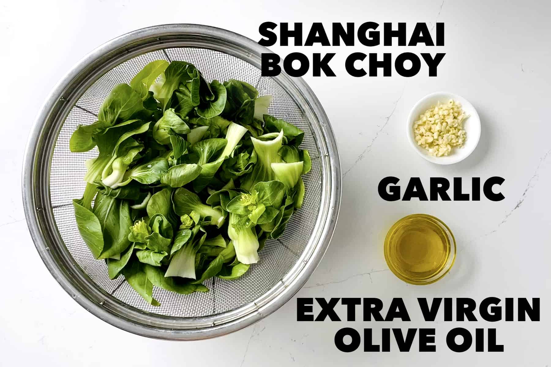 strainer of shanghai bok choy with bowl of garlic and olive oil