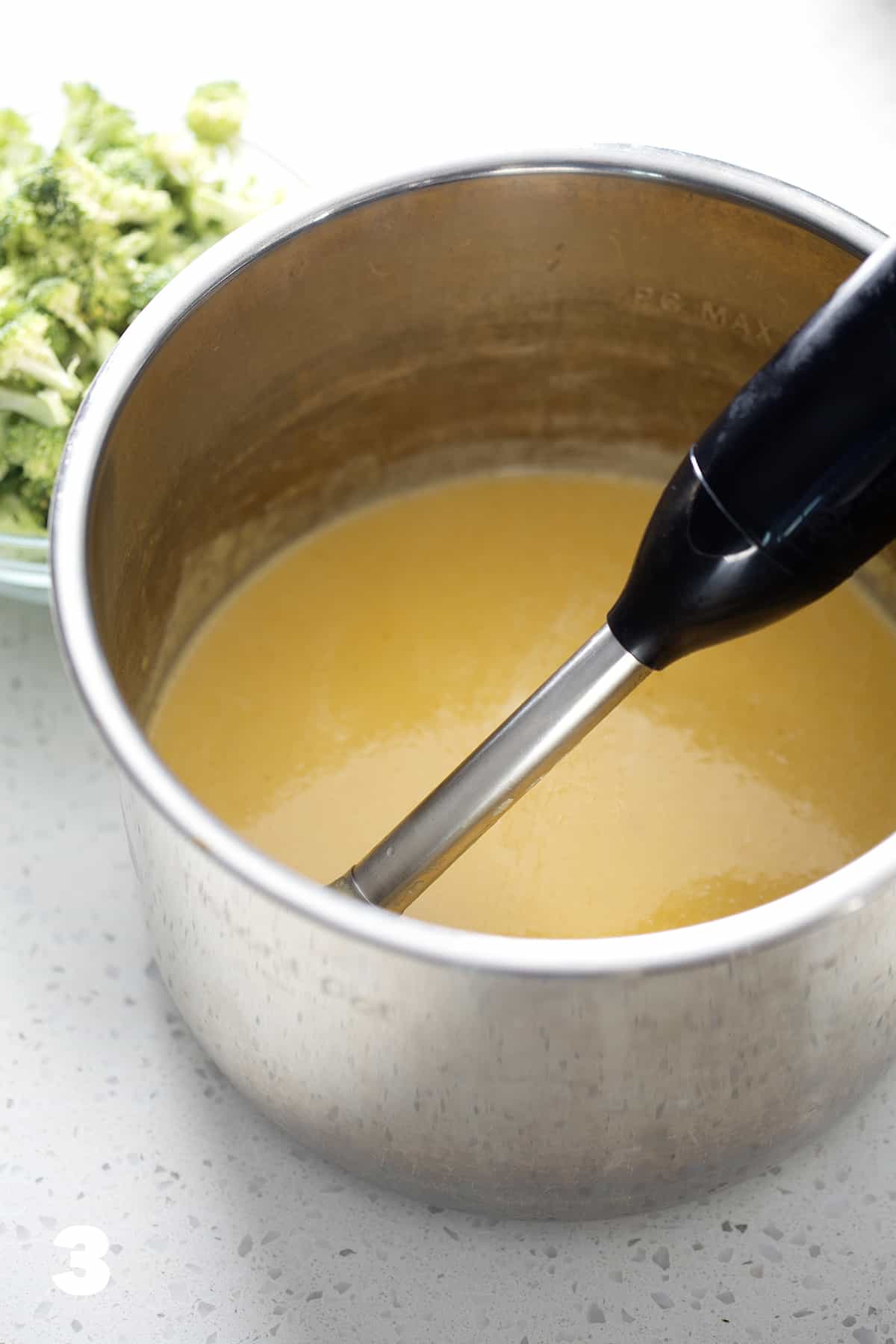 instant pot filled with soup and immersion blender
