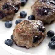 blueberry sausages on plate with fresh blueberries