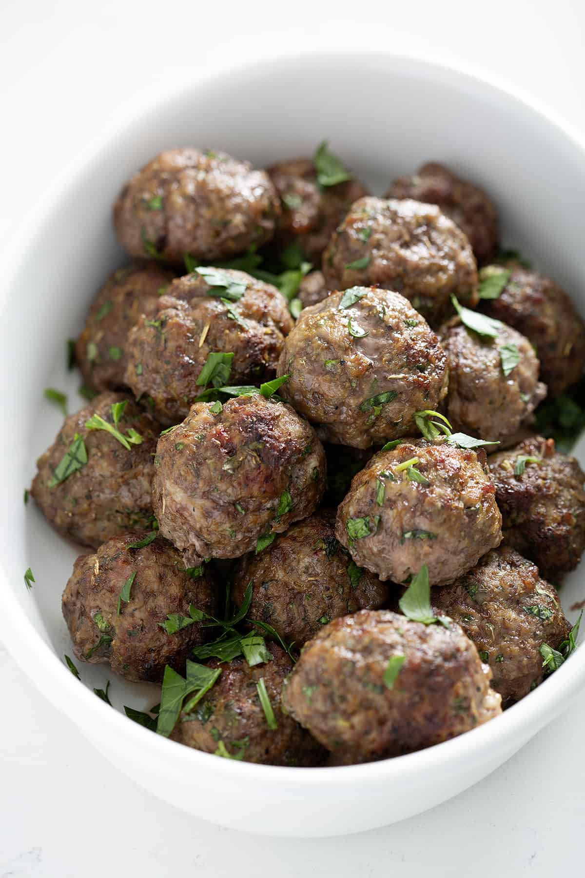 bowl of bison meatballs with chopped fresh parsley
