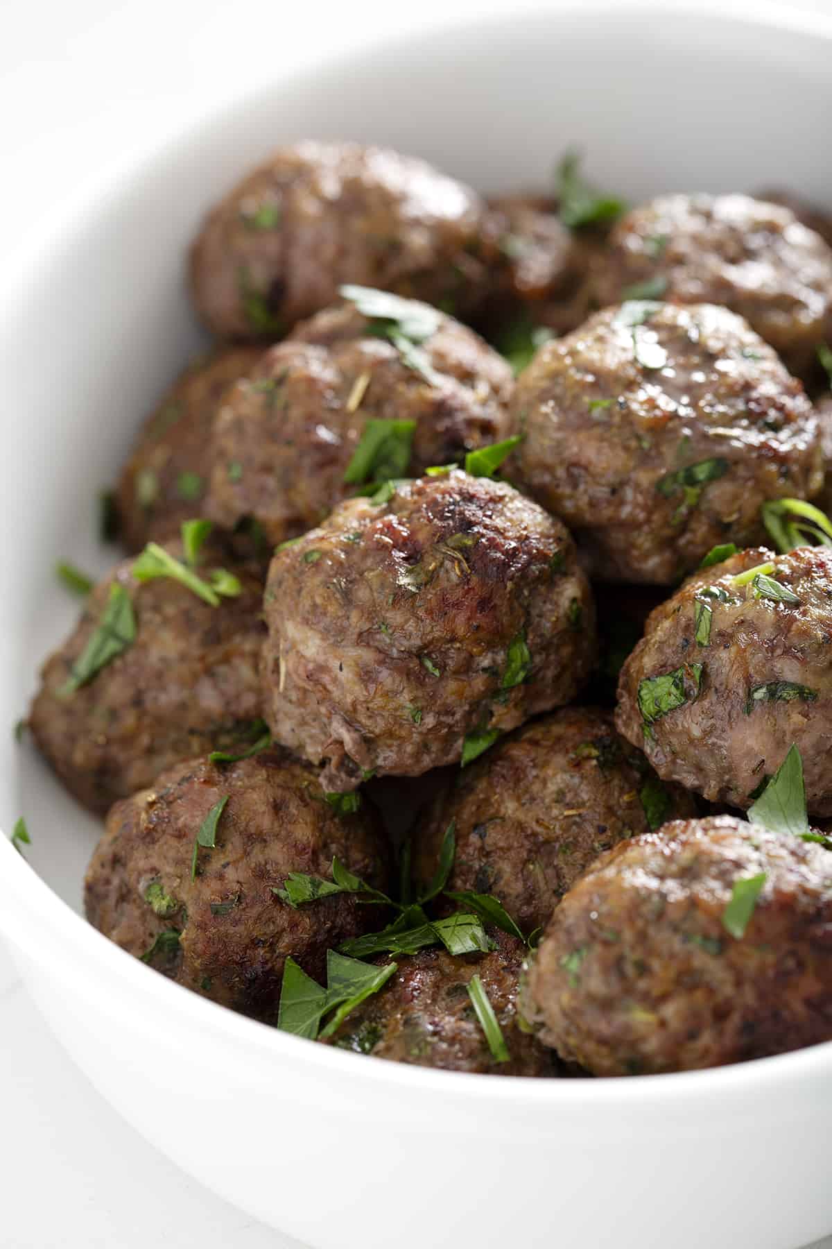 bowl of bison meatballs with fresh parsley