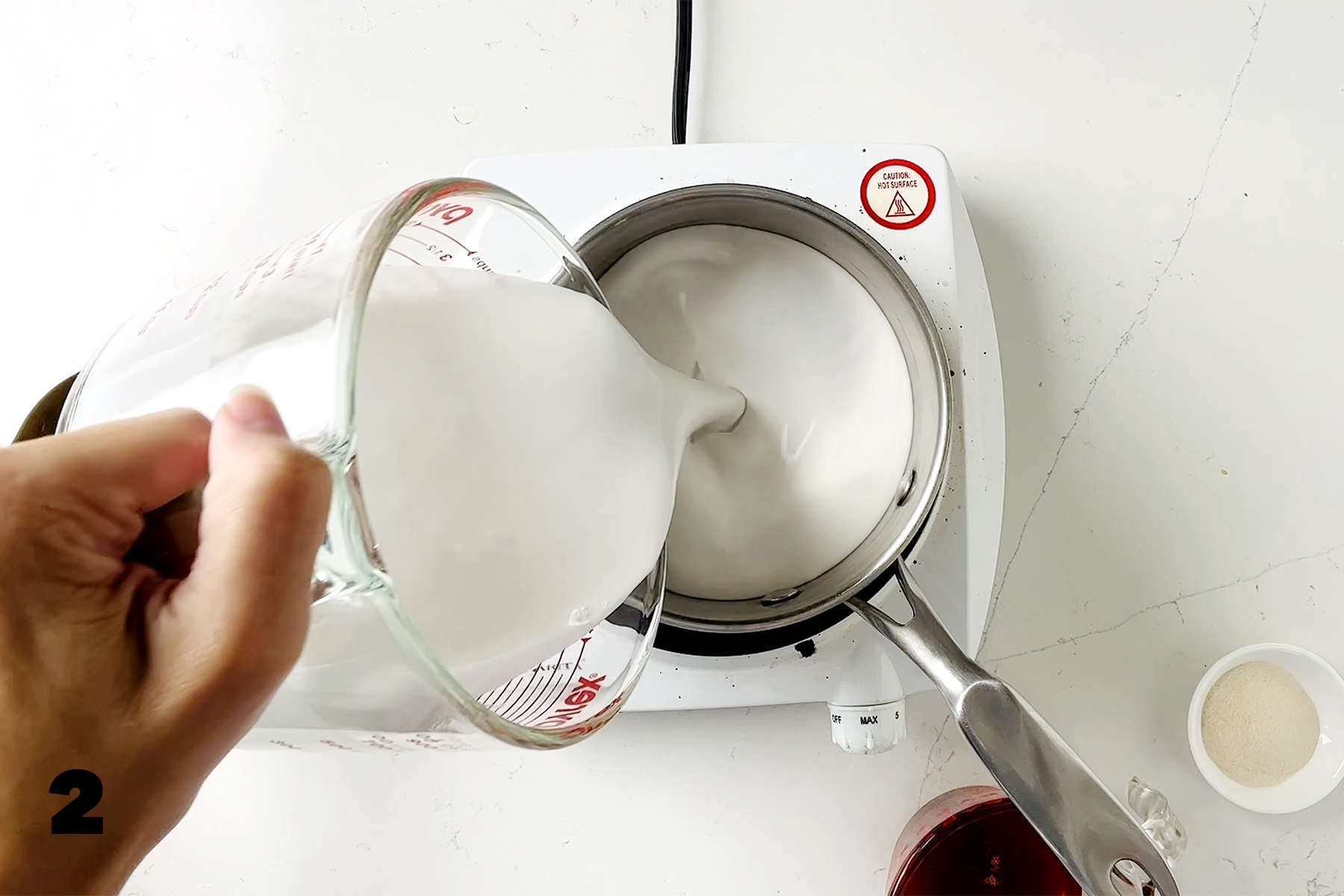 pouring coconut milk into saucepan