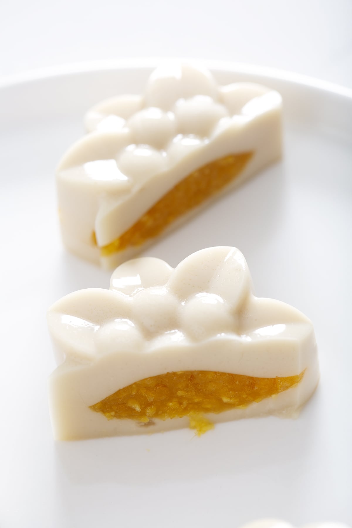 fruit jelly mooncake cut in half showing mango filled center