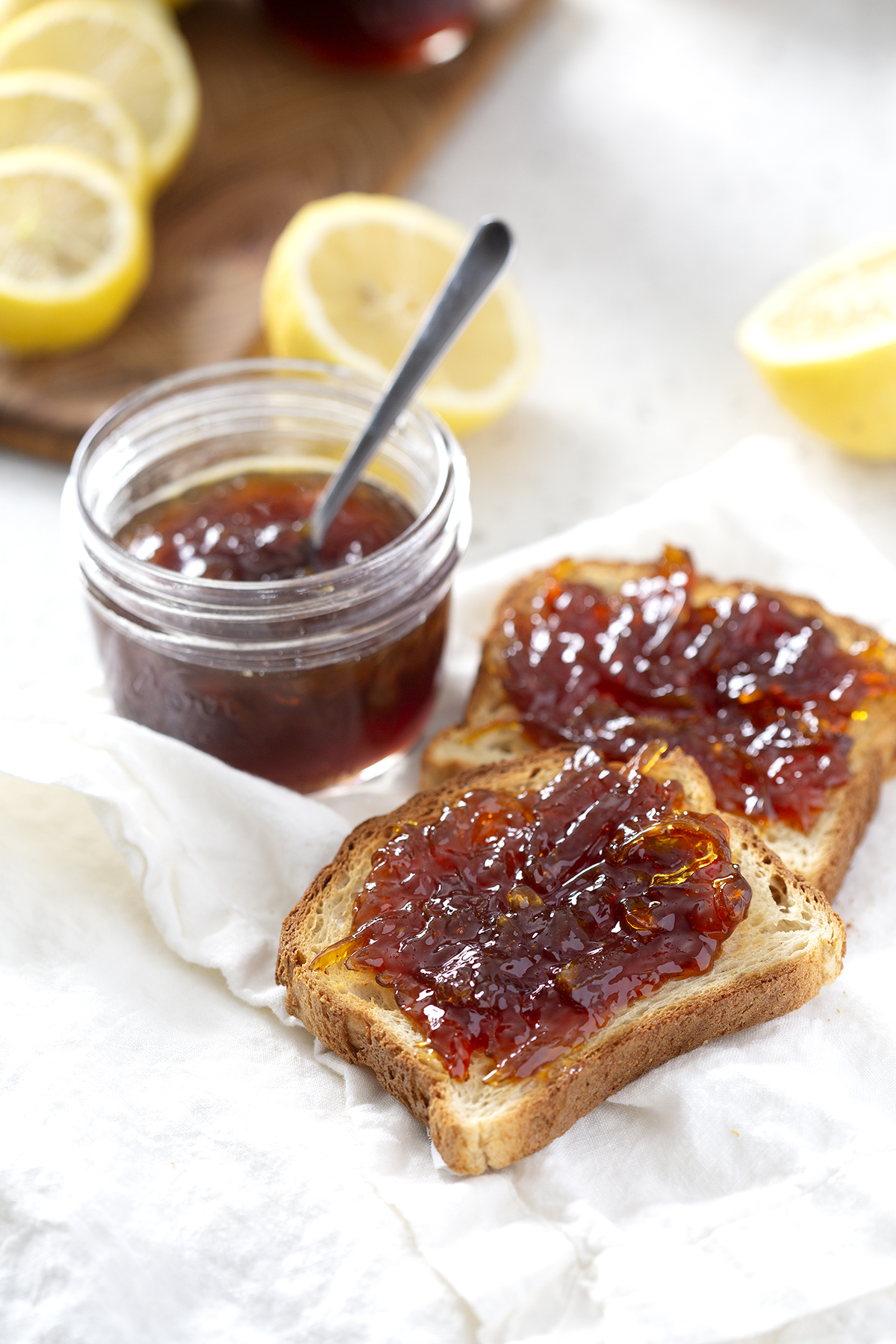 pieces of toast and mason jar with lemon honey marmalade