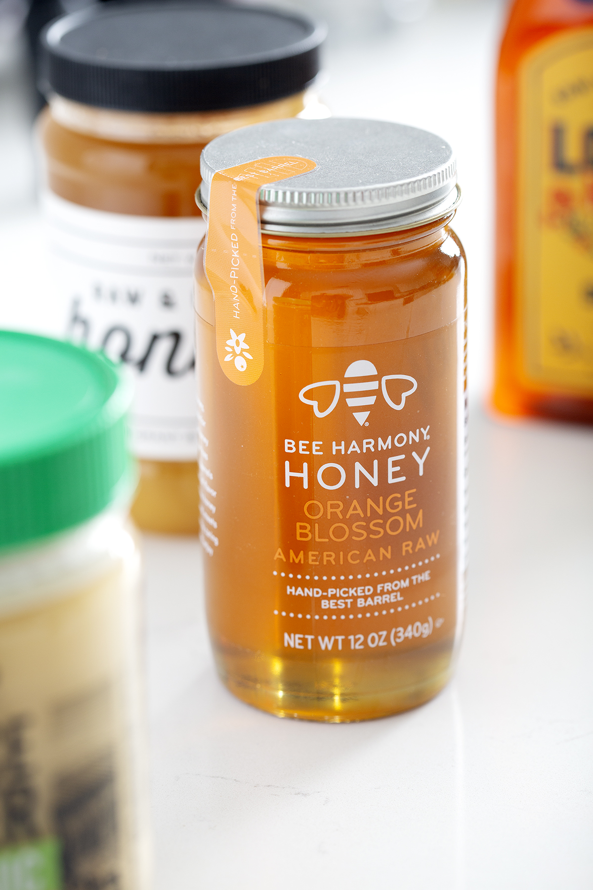 jar of bee harmony honey with more gluten free honey in background