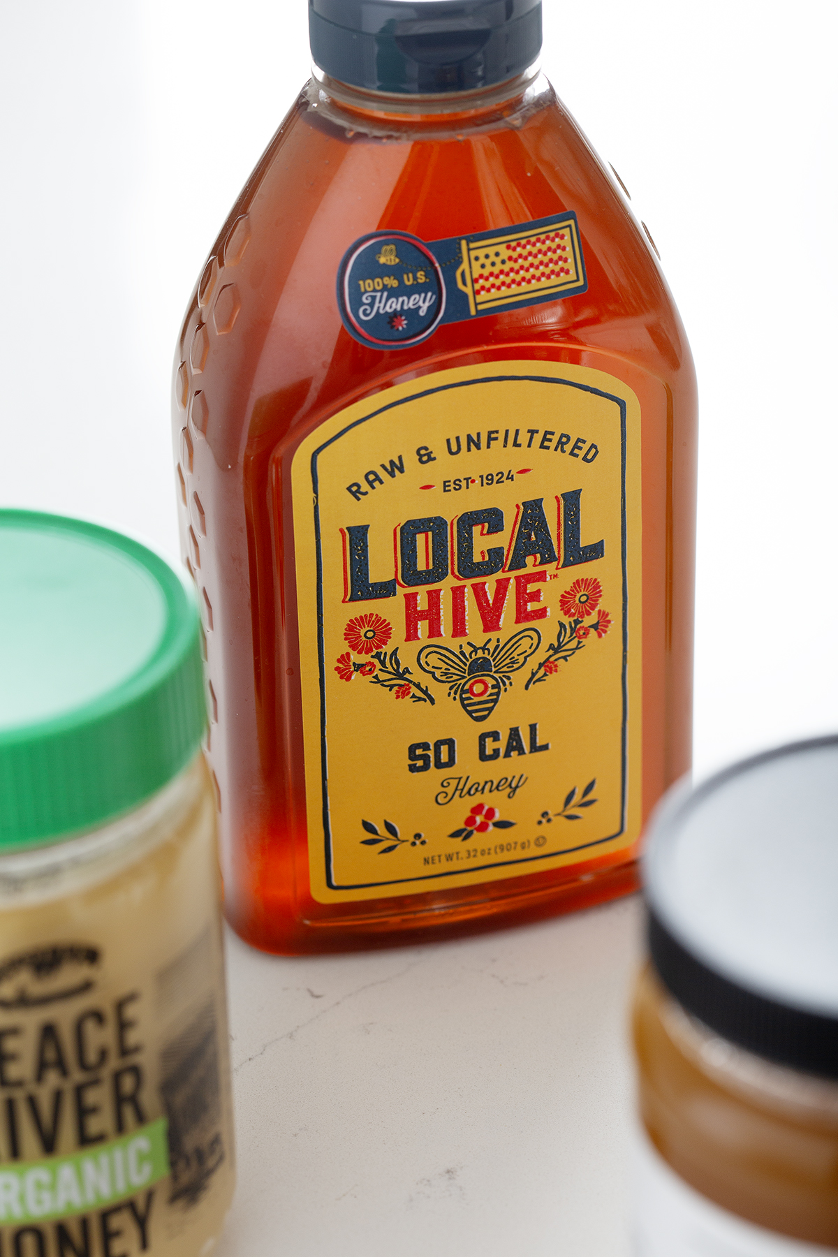 bottle of local hive honey on white background