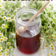 is honey gluten free written over jar of honey, dipper and flowers