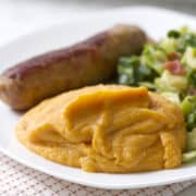 plateful of savory mahed sweet potatoes, sausage, brussel sprouts