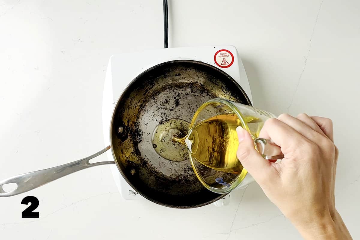 pouring oil into small frying pan