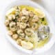 platter of shrimp scampi with text and lemons
