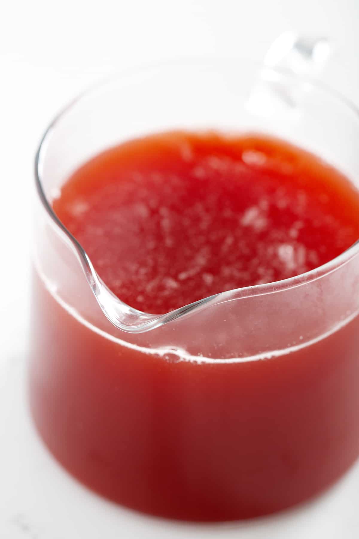 close up of red strawberry rhubarb simple syrup