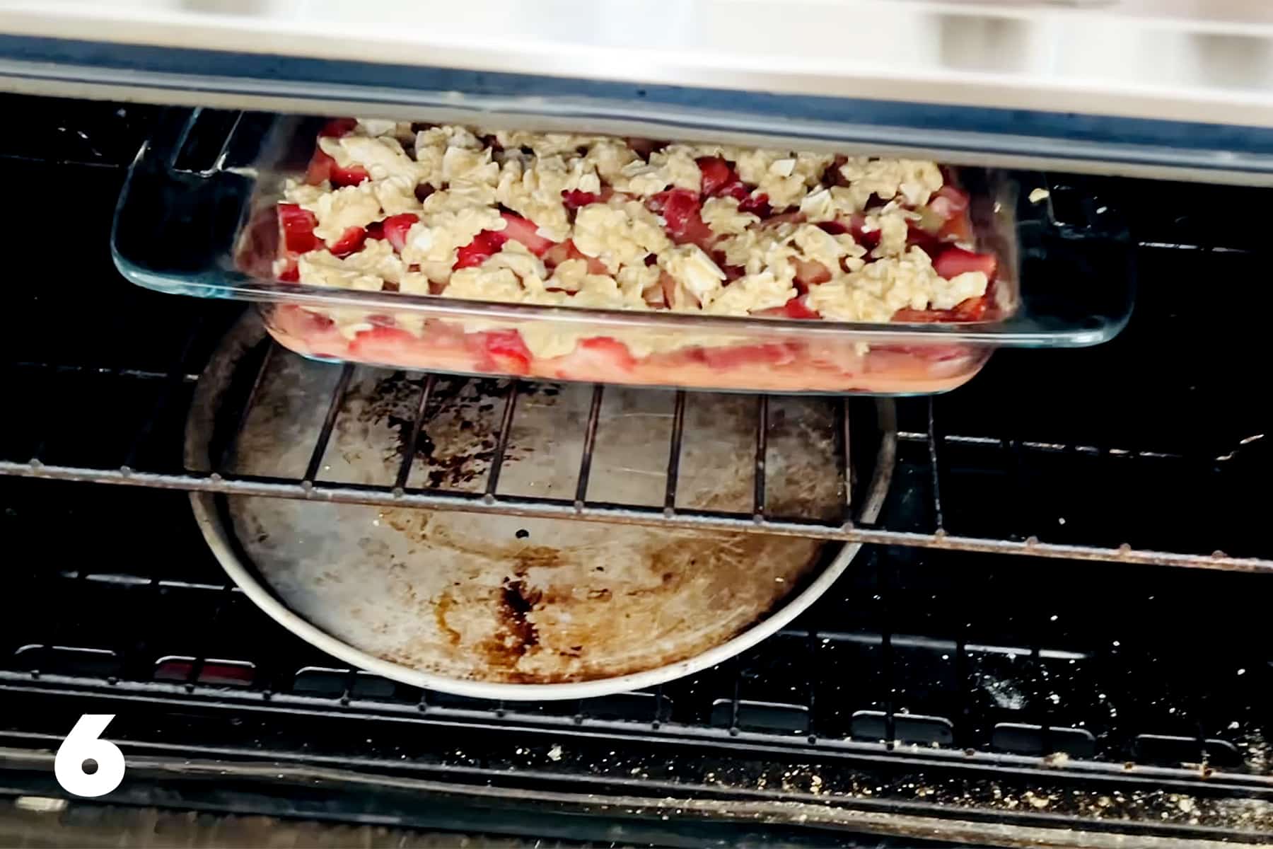 pan of gluten free strawberry rhubarb crisp in the oven