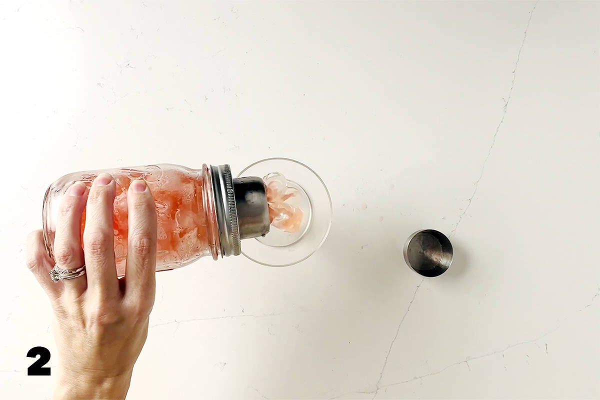 pouring drink from cocktail shaker