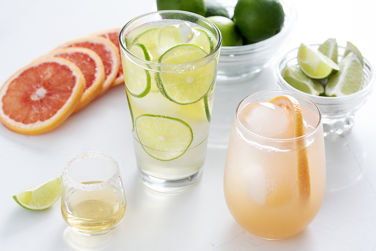three drinks made with tequila surrounded by garnishes
