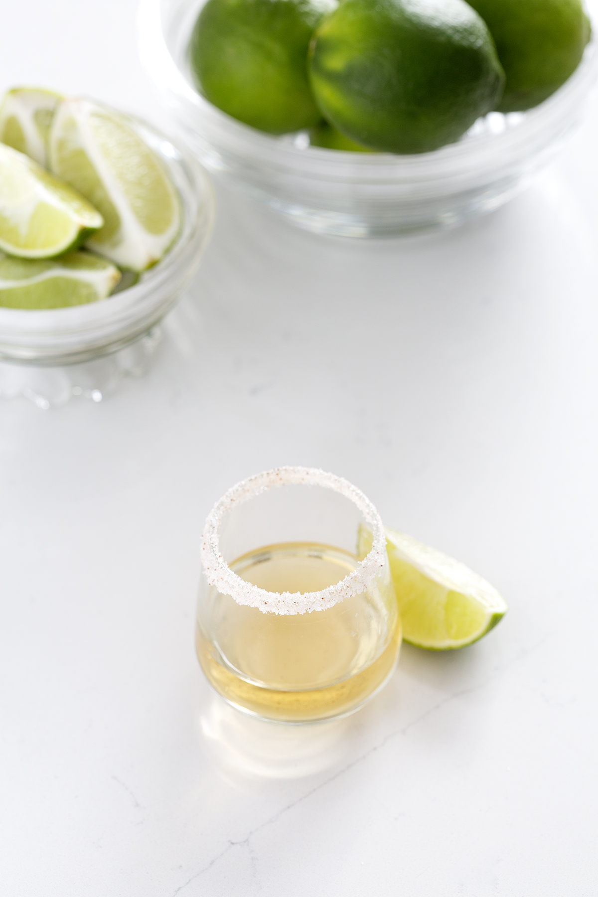 shot glass rimmed with salt with lime wedge