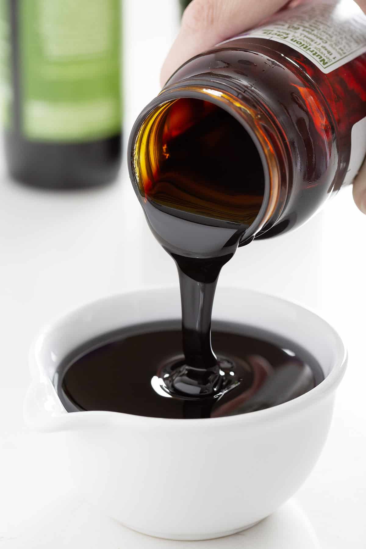 pouring molasses from jar into bowl