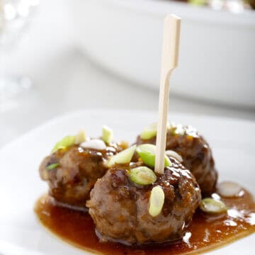 small plate of aip meatballs with sauce, green onions and toothpick