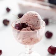 pink glass cup of AIP cherry ice cream with cherry